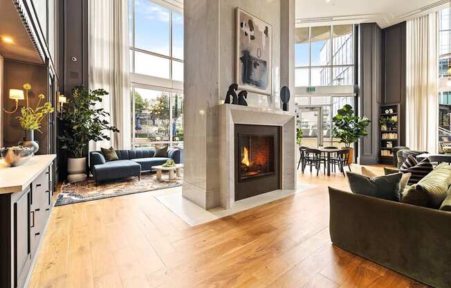 A modern living room with a fireplace and a large window.