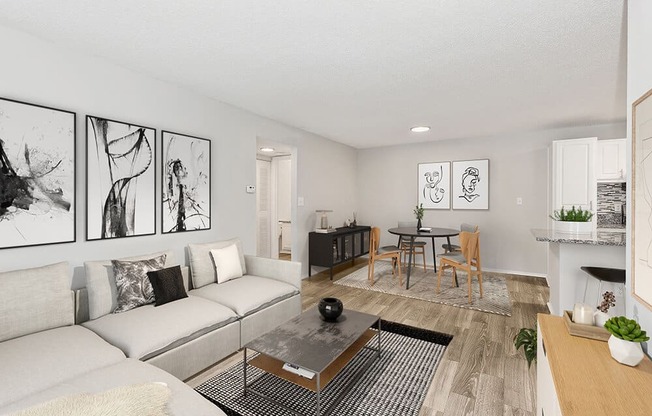 Model Living Room with Wood-Style Flooring and View of Kitchen/Dining Area at Seven Lakes at Carrollwood Apartments in Tampa, FL.