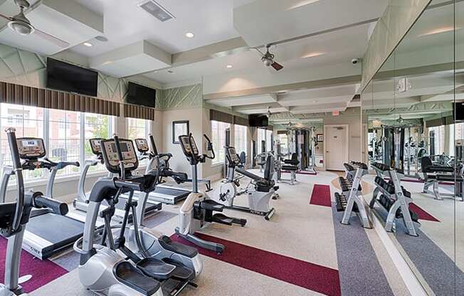 Fitness center with cardio equipment; flat screen TV
