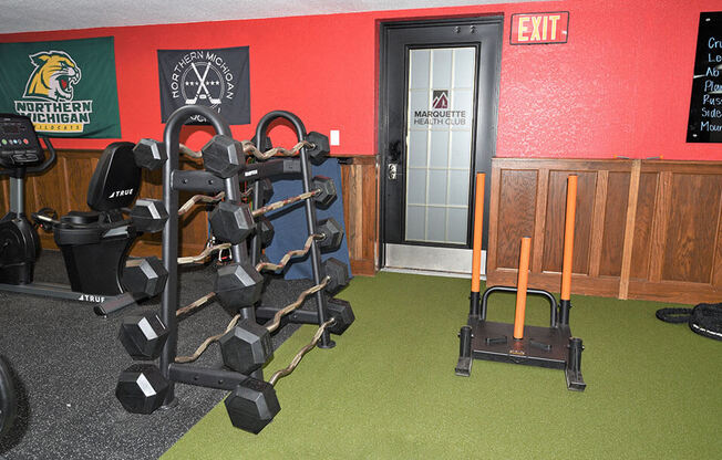 a room with a row of weights and a cart in it