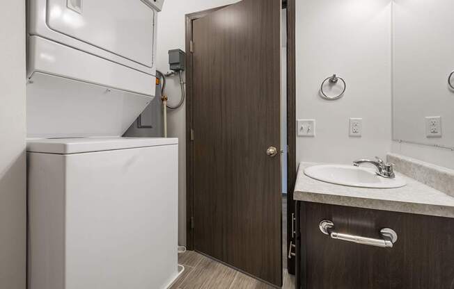 A bathroom with a white toilet and a brown door.