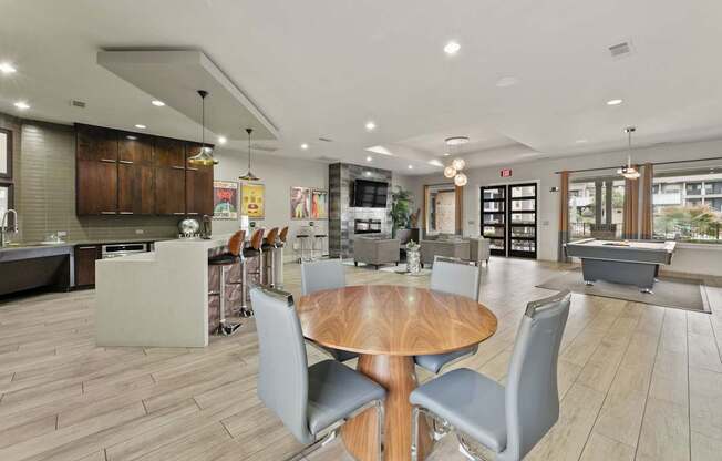 A modern kitchen with a dining table and chairs.