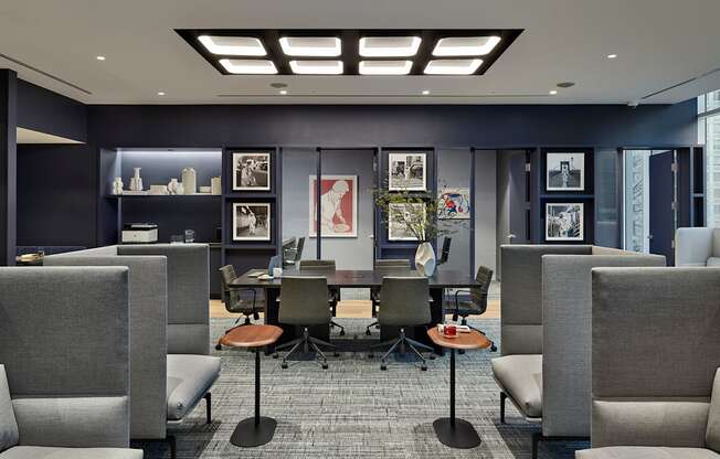 A modern office space with grey chairs and a carpeted floor.