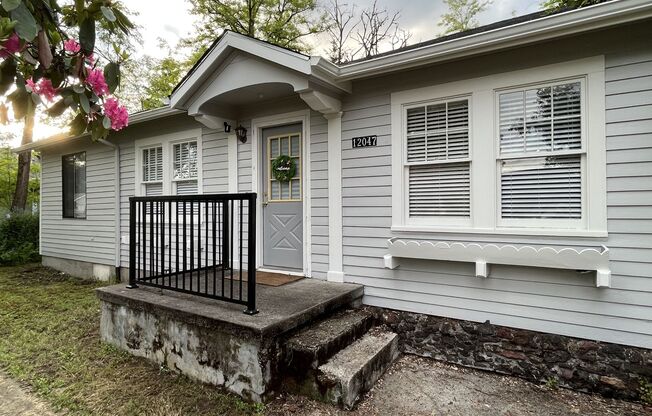 This 3-bedroom 1-bathroom house has a large front yard and a mostly fenced backyard.