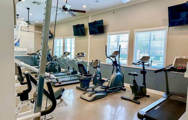 a gym with treadmills and other exercise equipment