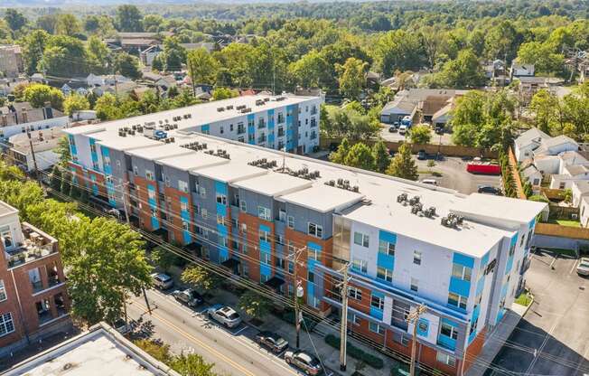A large apartment complex with a parking lot in front.