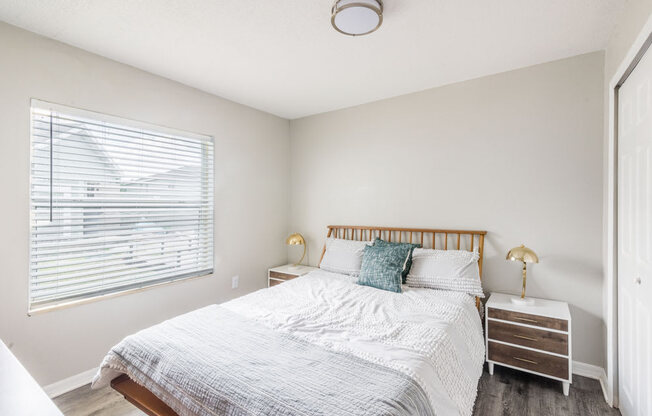 Bedroom with a bed and a window_Rolling Hills Apartments