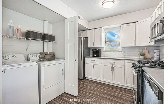 kitchen with white cabinets and stainless steel appliances at The Crossings Apartments, Michigan, 49508