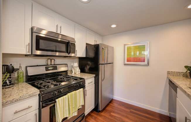 Kitchen Stove with Refrigerator, Hardwood Inspired Floor  and Microwave