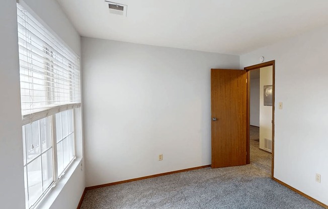 A room with a door and a window.