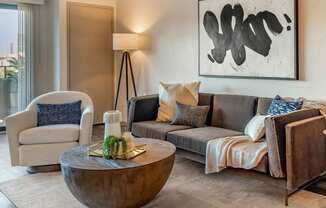 a living room with a couch and a table at The Rays at Vegas Towers Apartments, Nevada