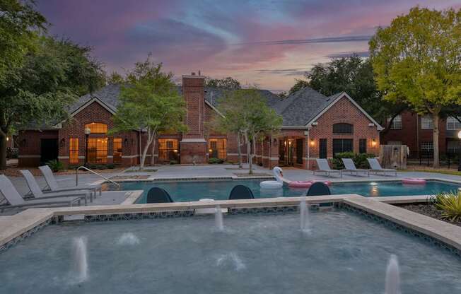 A pool with a fountain in the middle of it.