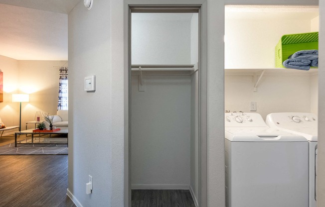 a laundry room with a washer and dryer and a closet with a sink