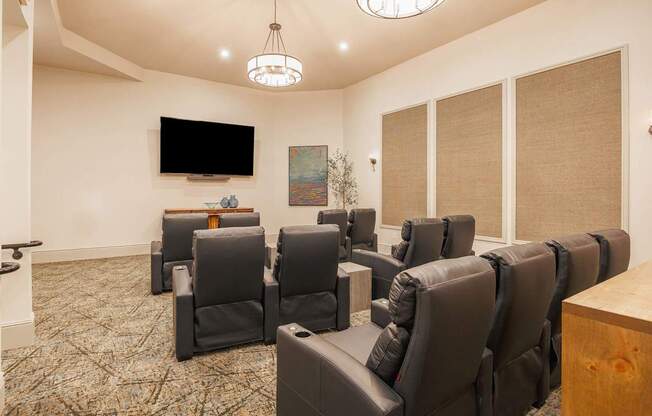 A room with a row of chairs and a television mounted on the wall.