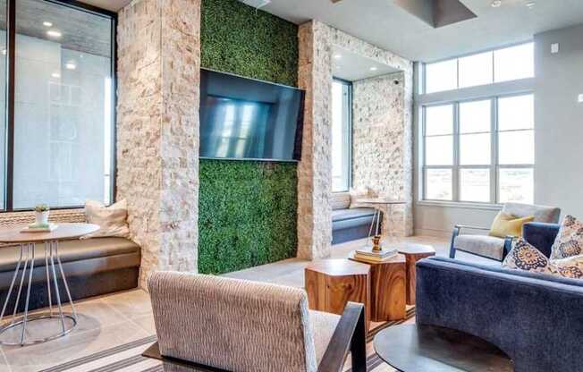 A living room with a couch, a chair, a table, and a green wall.