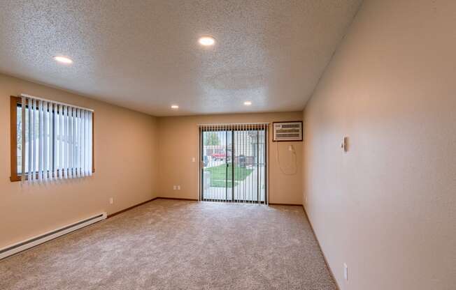 Grand Forks, ND Richfield Apartments. A living room with a sliding glass door to a patio