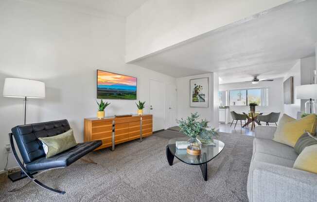 a living room with a couch and a glass coffee table