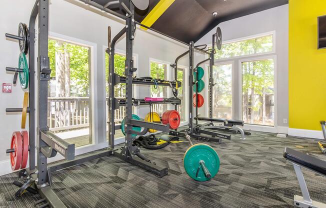 Lift weights in a bright open atmosphere at Madison Landing at Research in Madison, AL