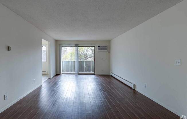 A room with wooden floors and white walls.