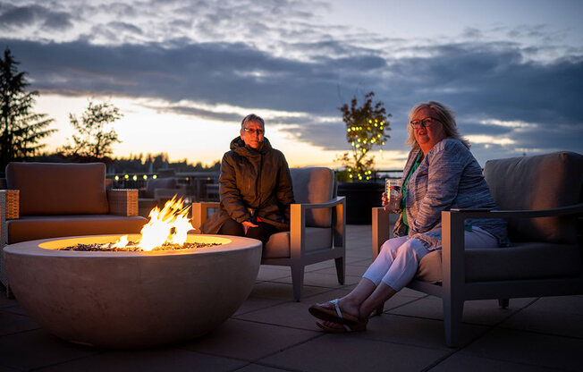 residents at fire pit at Harbor Heights 55+ Community, Washington, 98501