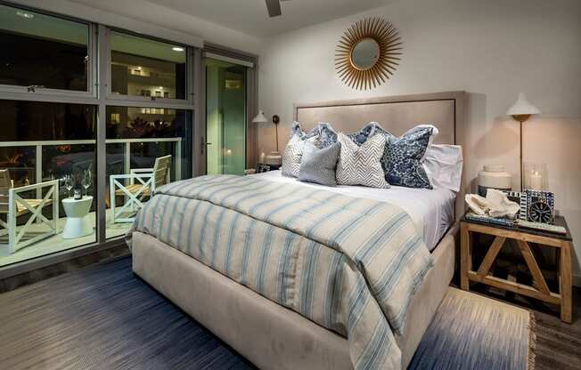 A bedroom with a large bed and a ceiling fan.