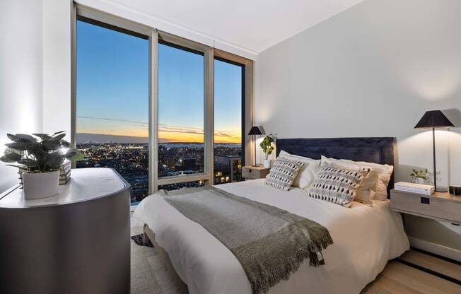 a bedroom with a bed and a view of the city at The Paxton, Brooklyn