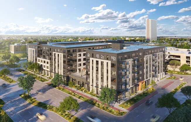 an aerial view of an apartment complex with buildings and a parking lot