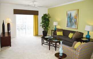 Living Room With Ceiling Fan and Door To Patio or Balcony