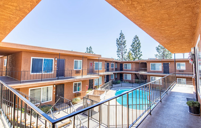 a balcony with a pool and a building with balconies