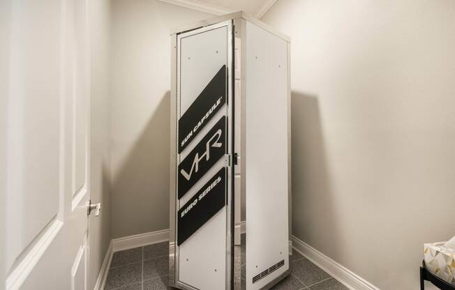 a small refrigerator in a small room in a room with white walls  at Arlo Luxury homes Apartments, Little Rock