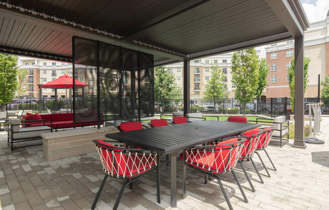 a dining area with a table and chairs under a patio