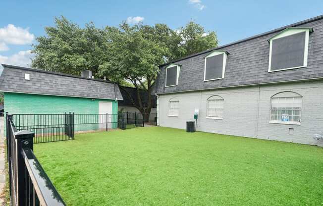 the backyard of a house with a yard and a fence