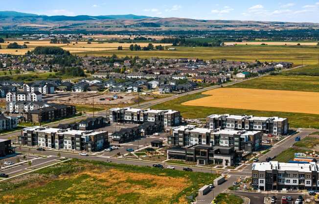 an aerial view of a city with buildings and a field