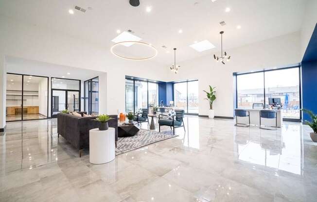 a large living room with a couch and chairs in front of glass doors