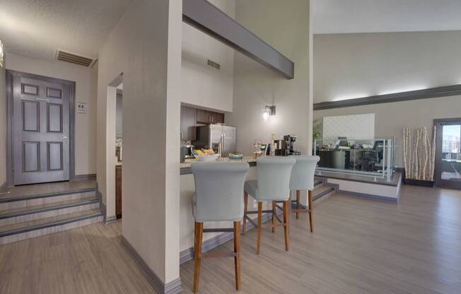 A dining room with a table and chairs.