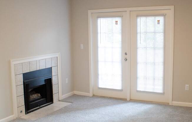 Enclave at Wolfchase Apartments in Cordova Tennessee photo of a living room with a fireplace and a ceiling fan