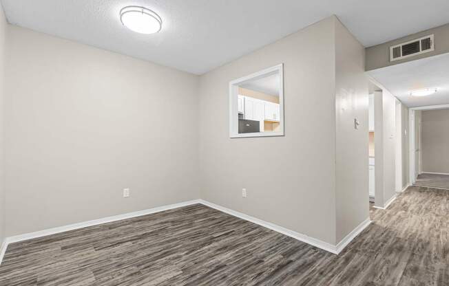 A room with a wooden floor and a window.