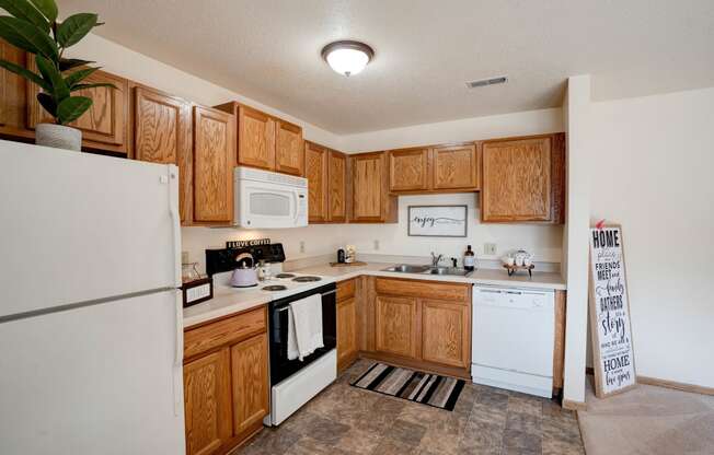 Fully-Equipped Kitchen With White Appliances