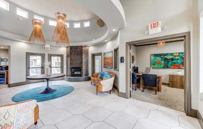 A large room with a blue rug and a fireplace.