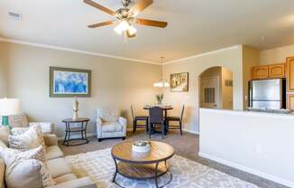 A living room with a white couch and a ceiling fan.