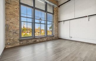 Living room with large window and wood floors