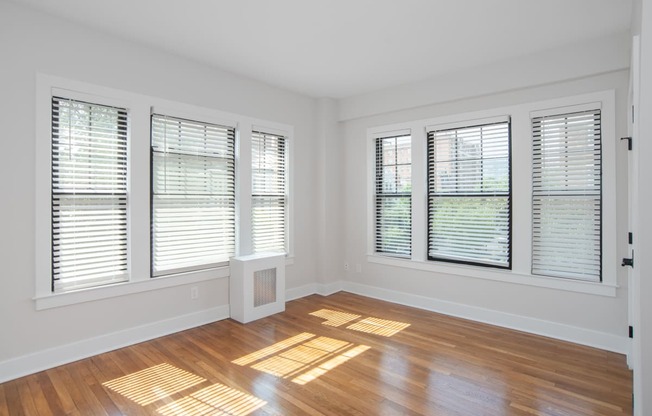 a living room with wood floors and windows