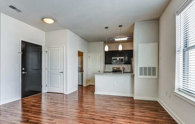 An empty living room with a kitchen in the background at The View at Old City, Philadelphia