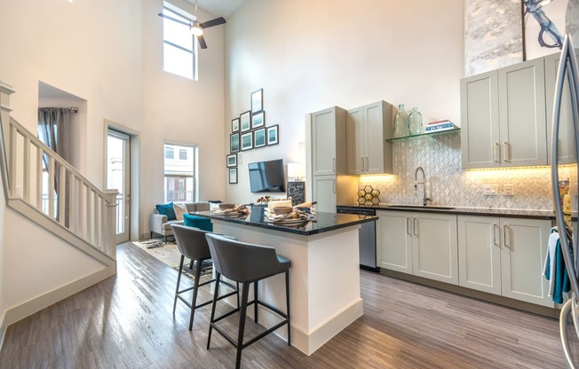 Kitchen area facing exterior patio door and staircase from the living room