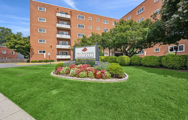 A large brick building with a sign in front of it.