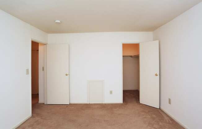 a group of white men standing in a room with white doors