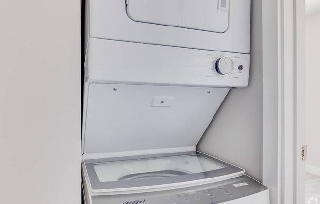 a washer and dryer in a white laundry room