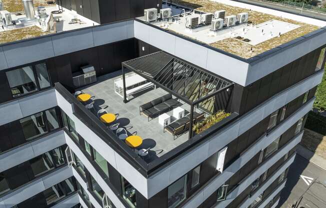 a large building with a rooftop terrace on top of it at Analog PDX Apartments, Oregon 97227