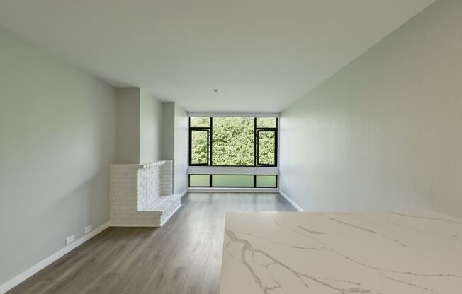 a living room with a large window and a marble table