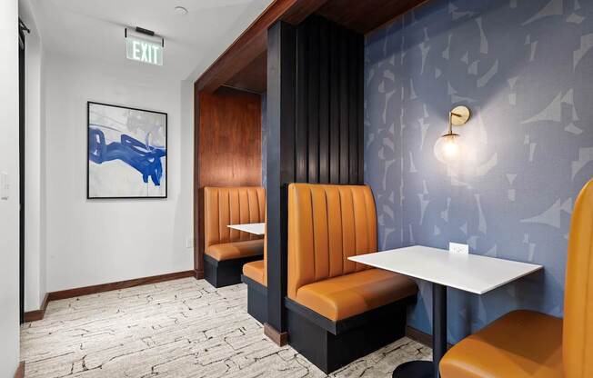 A restaurant interior with a blue wallpaper and a white table.